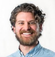 A smiling man with a beard.